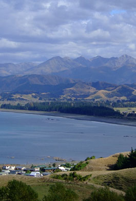 Kaikoura Peninsula, looking south, the village of South Bay below, and the Hundalee Hills and Seaward Kaikoura range accross the water